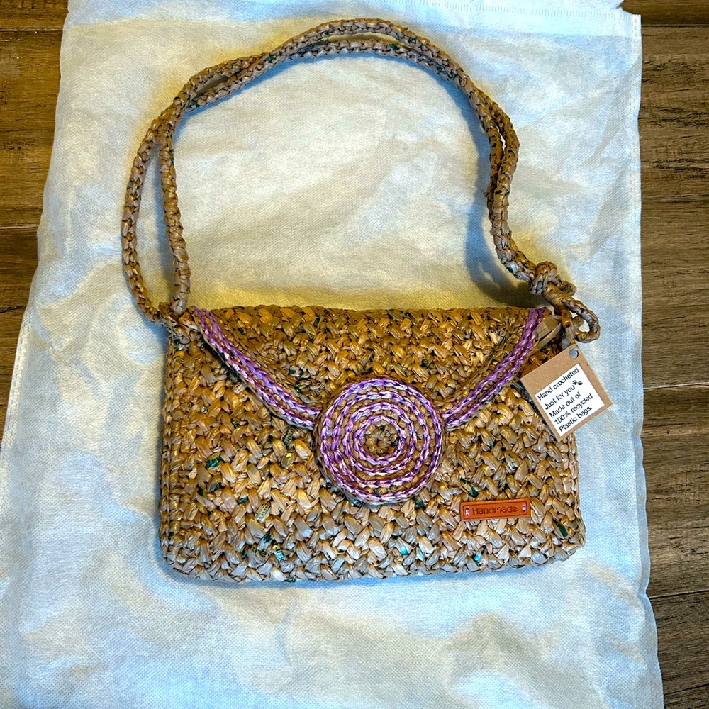 Has snap closure and adjustable sliding strap. New with tags